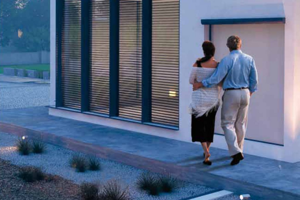 Couple walking next to building secured by BTicino video door entry system